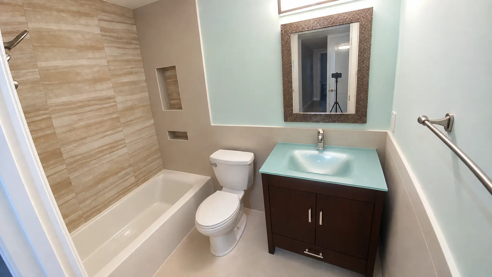 Modern bathroom vanity with framed mirror and wall sconce lighting